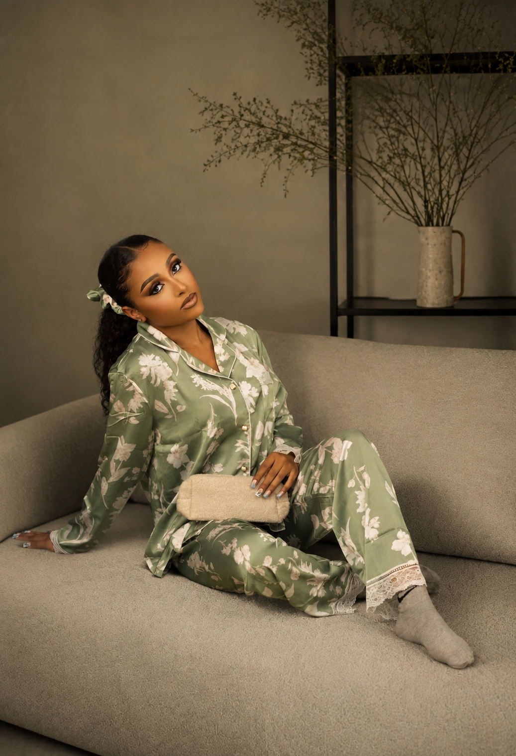 The Status Set, seated on the sofa